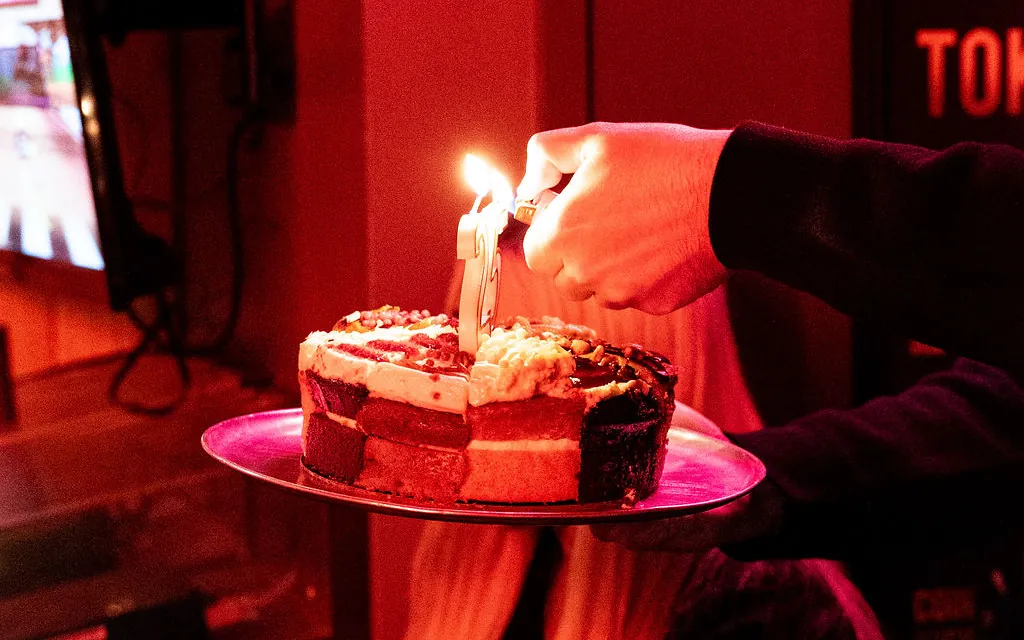 Candle being lit on a birthday cake at Bartronica